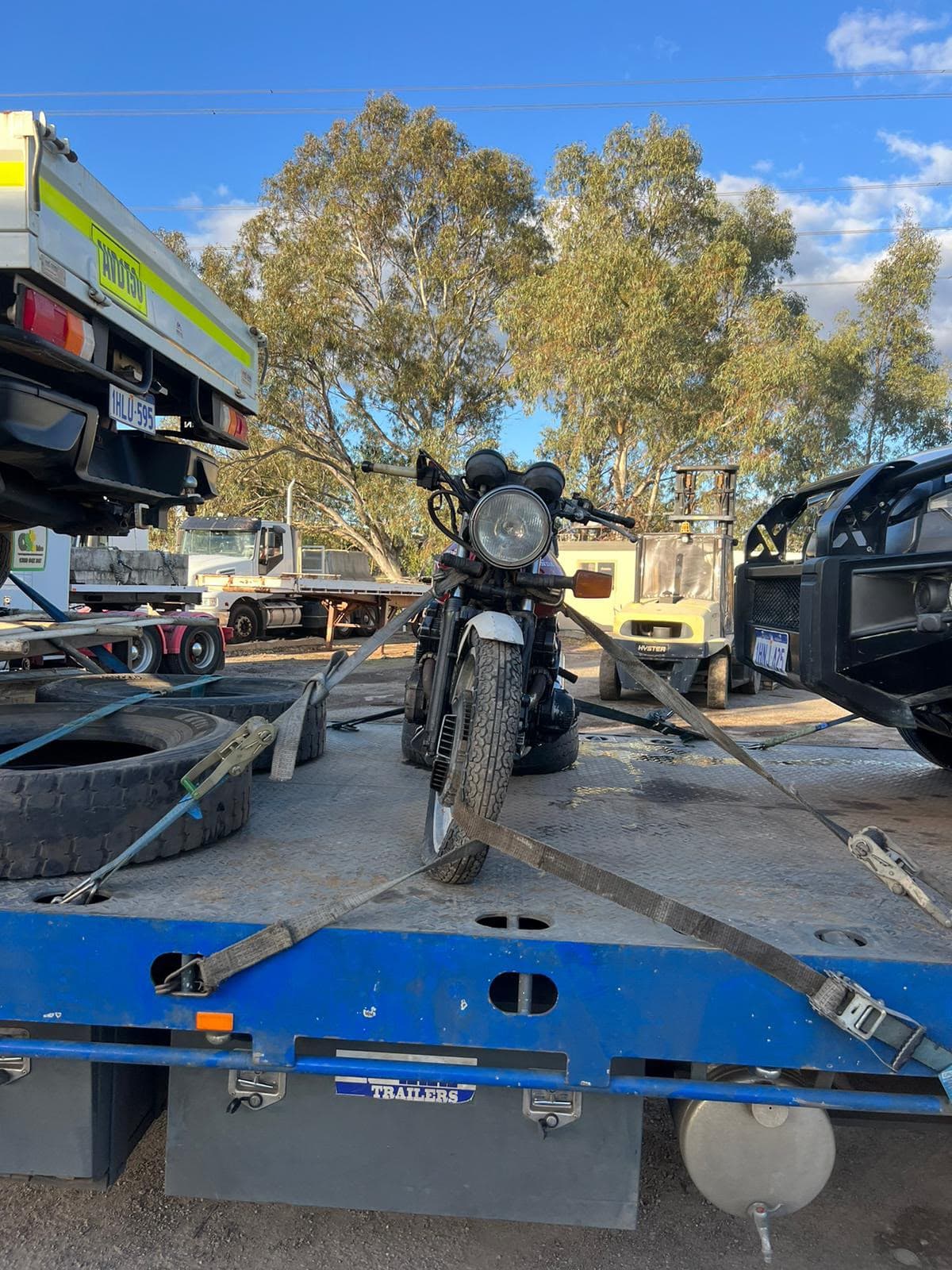 Motorbike strapped upright on a flatbed