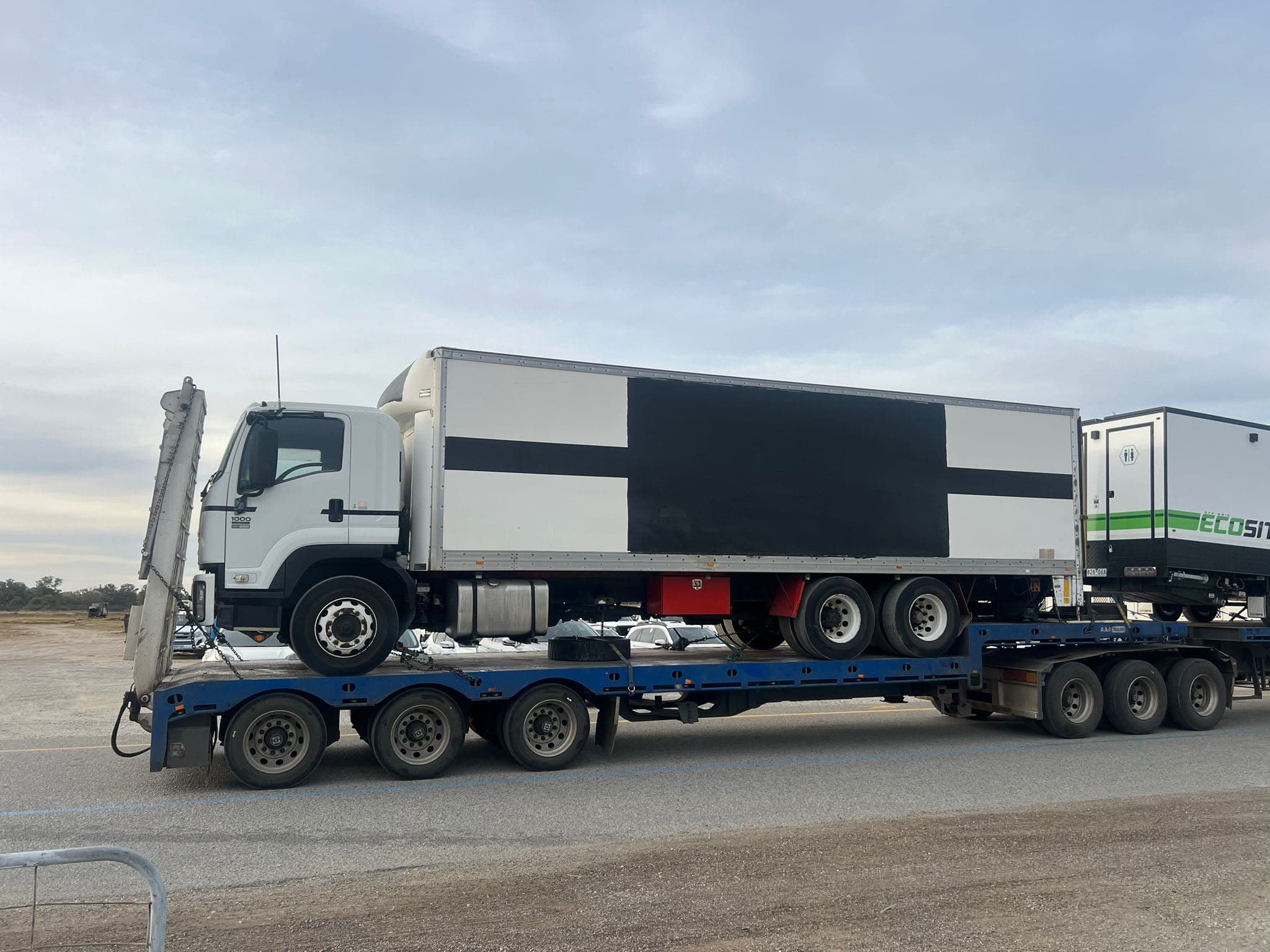 Box truck secured on a drop-deck trailer