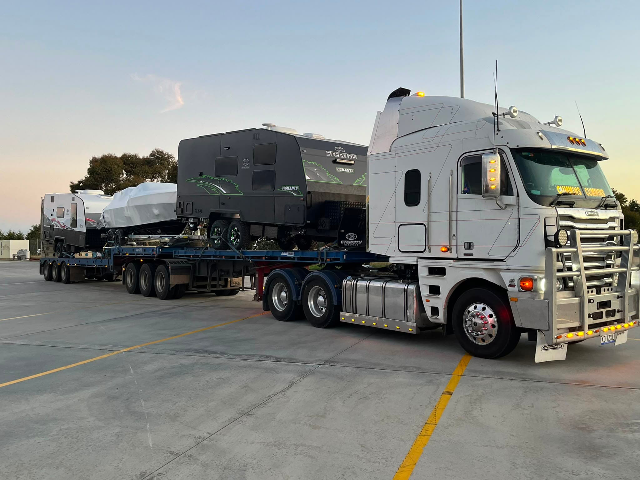 GNDJ Haulage road train loaded with two caravans and a boat